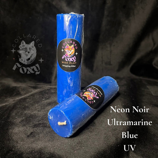 Ultramarine blue UV reactive paraffin dripping pillar candles on black velvet with Neon Noir label