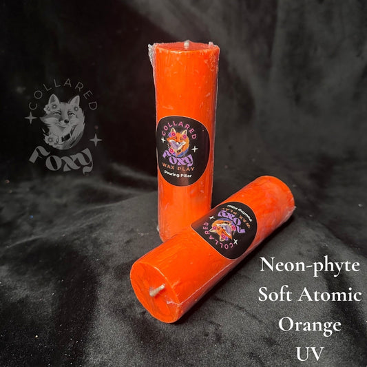 Soft Atomic orange Neon-phyte pouring pillar candles on black velvet with Neon-phyte label