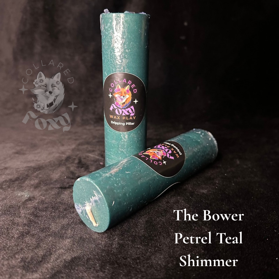 Petrel Teal blue-green shimmer wax play candles, labelled, on black velvet